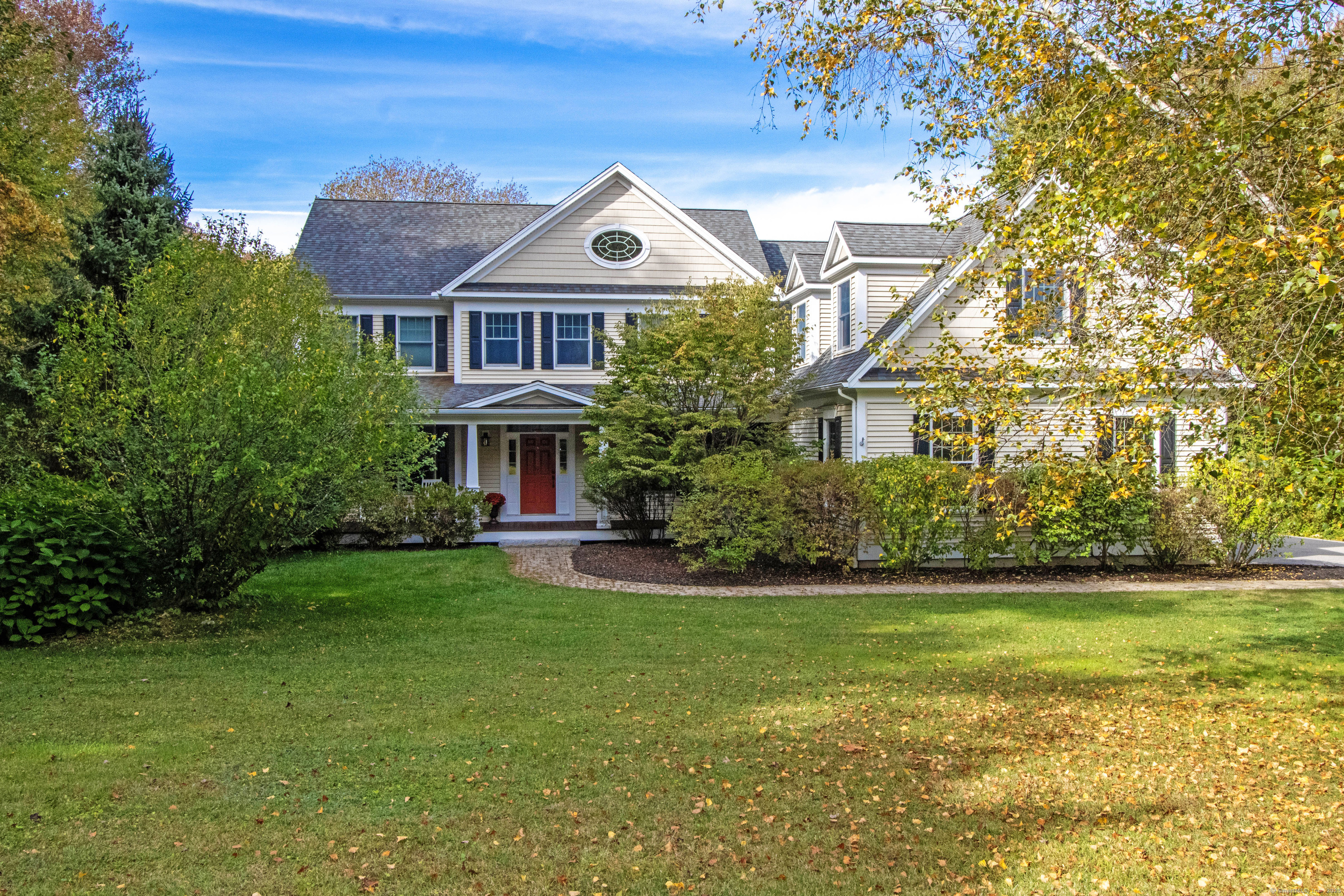 a front view of a house with a garden