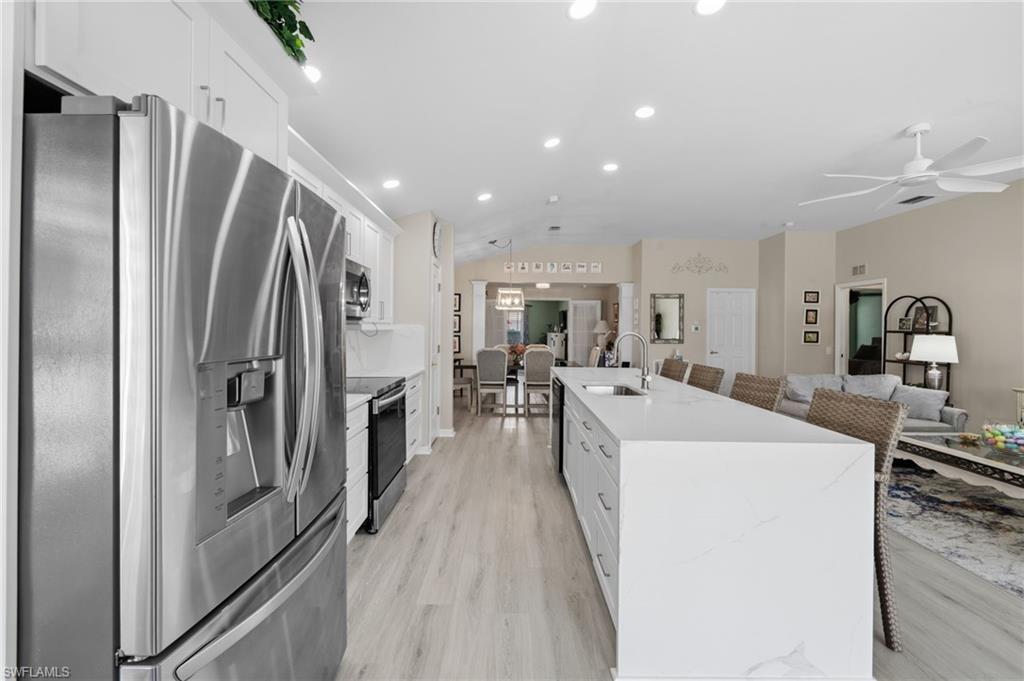 10020 Horse Creek Road Fort Myers, FL 33913 - Photo 11 of 31 a kitchen with stainless steel appliances granite countertop a refrigerator and a sink