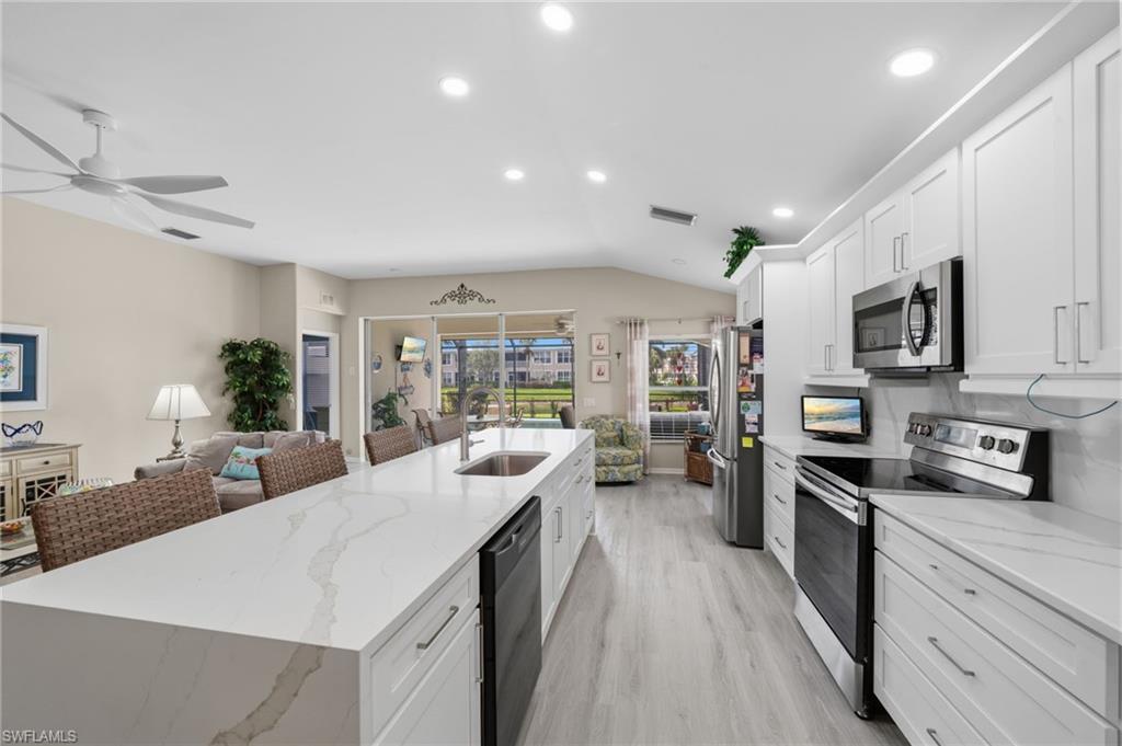 10020 Horse Creek Road Fort Myers, FL 33913 - Photo 13 of 31 a large kitchen with stainless steel appliances lots of counter space and wooden floor