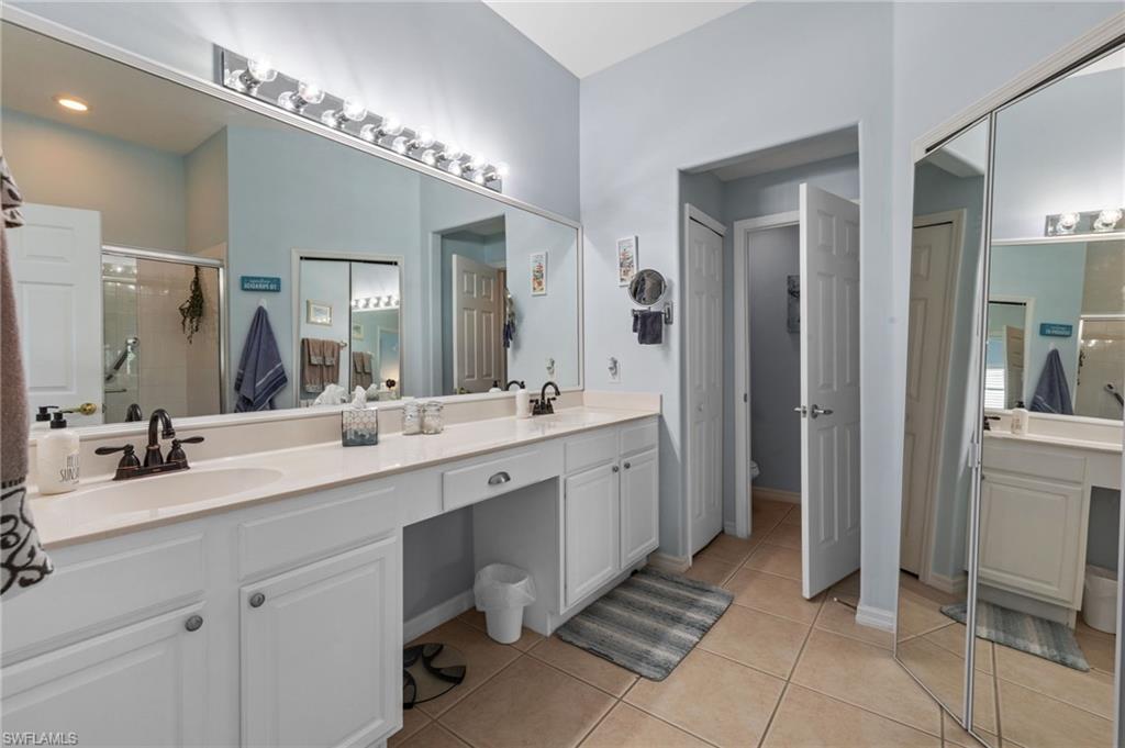10020 Horse Creek Road Fort Myers, FL 33913 - Photo 20 of 31 a spacious bathroom with a double vanity sink a mirror and a shower