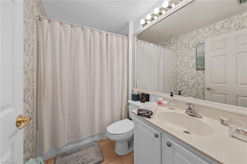 10020 Horse Creek Road Fort Myers, FL 33913 - Photo 23 of 31 a bathroom with a sink a toilet and shower curtain