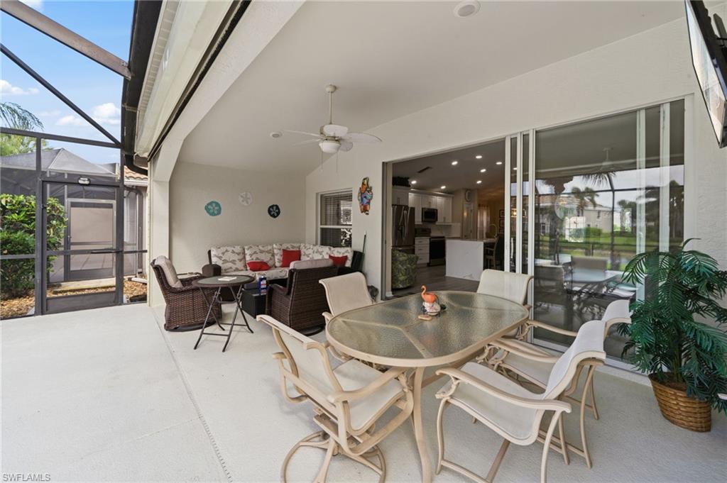 10020 Horse Creek Road Fort Myers, FL 33913 - Photo 28 of 31 a dining room with furniture a floor to ceiling window and potted plants