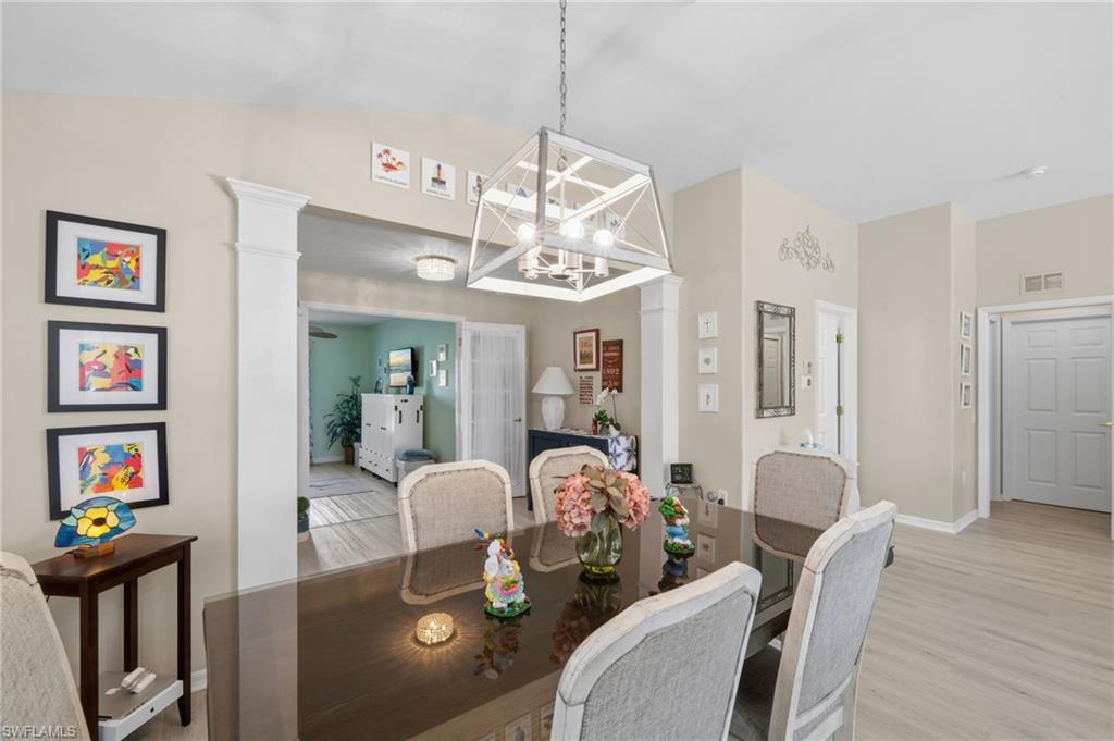 10020 Horse Creek Road Fort Myers, FL 33913 - Photo 8 of 31 a view of a dining room with furniture a chandelier and wooden floor