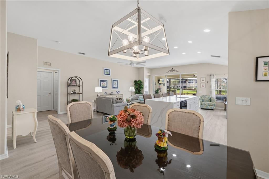 10020 Horse Creek Road Fort Myers, FL 33913 - Photo 9 of 31 a dining room with furniture a chandelier and wooden floor
