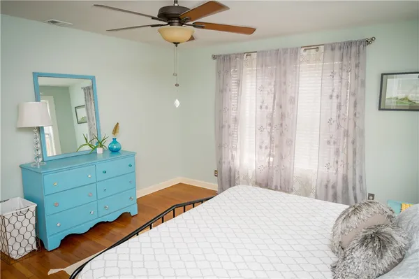 a bedroom with a bed and a dresser