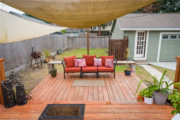 a view of a patio with couches chairs and wooden floor