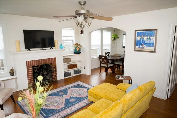 a living room with furniture fireplace and flat screen tv