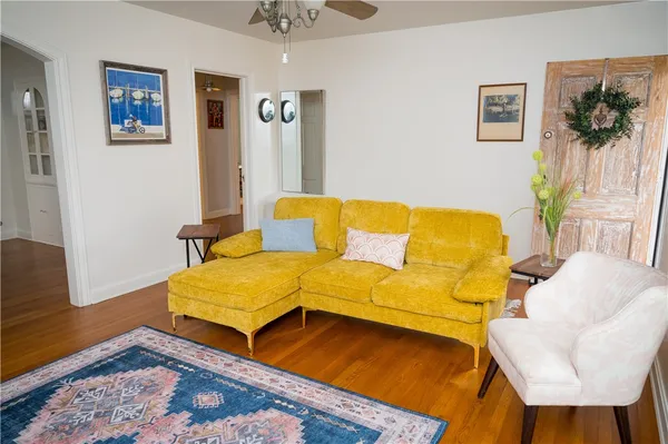 a blue couch sitting in a living room with a rug