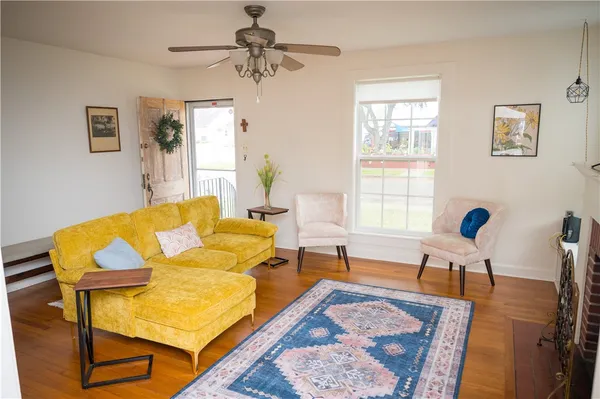 a living room with furniture and wooden floor