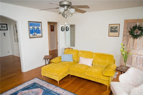 a blue couch sitting in a living room next to a window