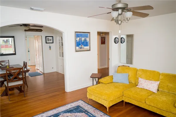 a living room with furniture and a wooden floor