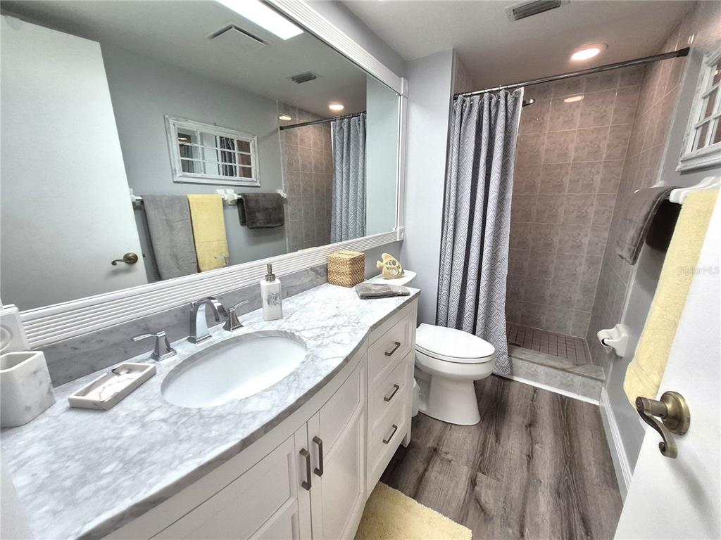 107 Windward Place, Unit 107 Oldsmar, FL 34677 - Photo 23 of 34 a bathroom with a granite countertop sink toilet and shower