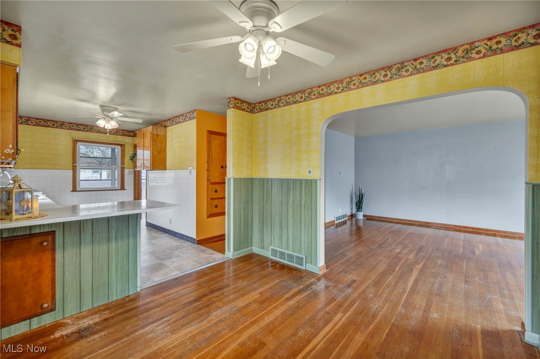 367 High Grove Boulevard Akron, OH 44312 - Photo 12 of 46 Kitchen featuring arched walkways, a ceiling fan, wallpapered walls, and visible vents