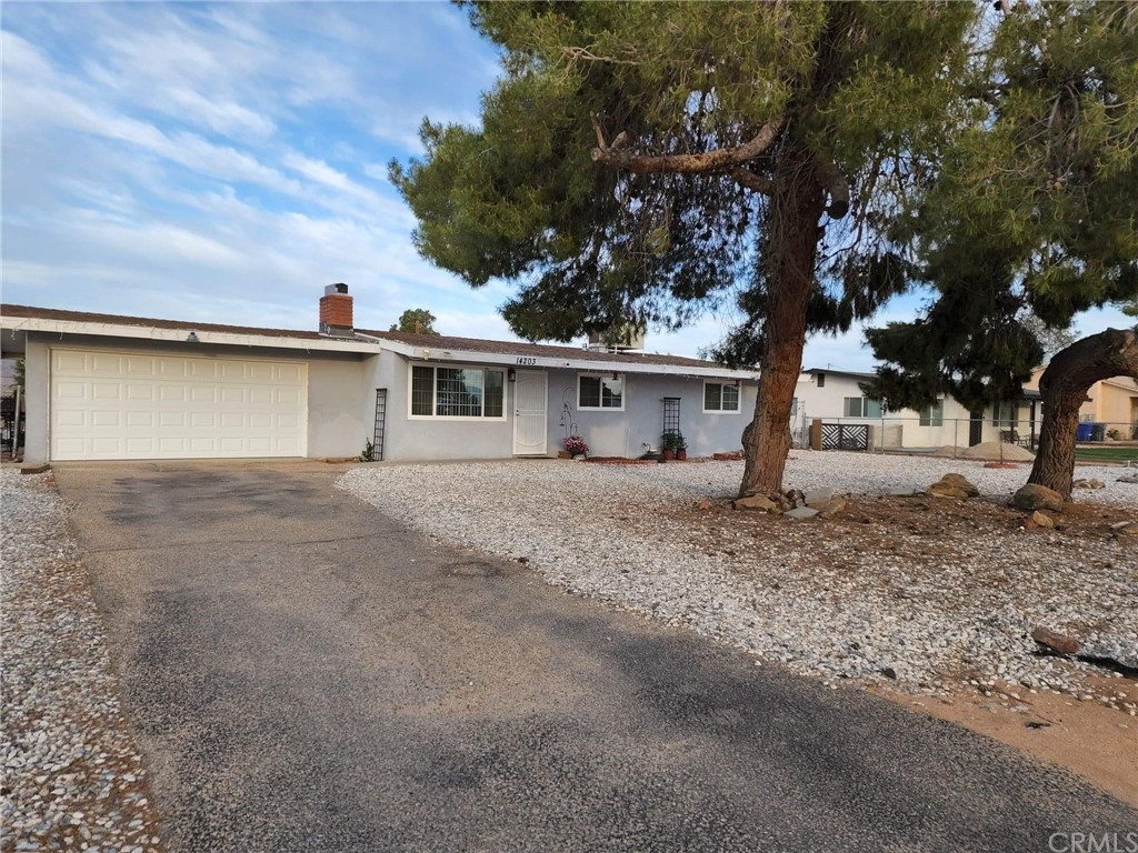 14203 Pawnee Road Apple Valley, CA 92307 - Photo 1 of 1 a view of a house with a backyard