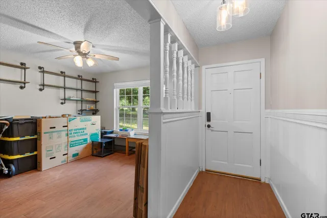 a view of room with workspace and windows