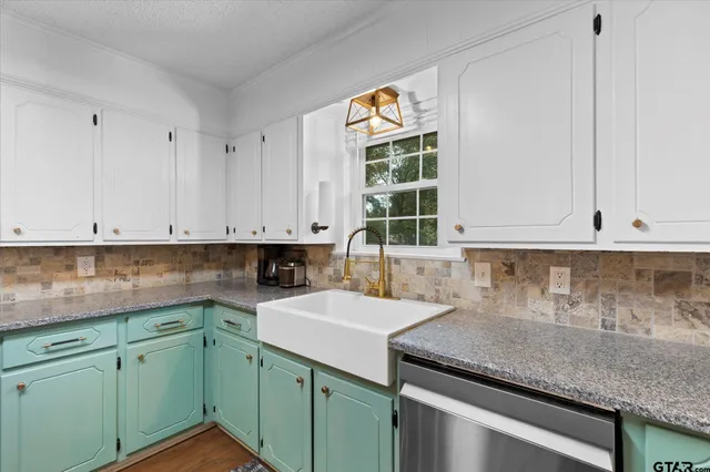 a kitchen with a sink and cabinets