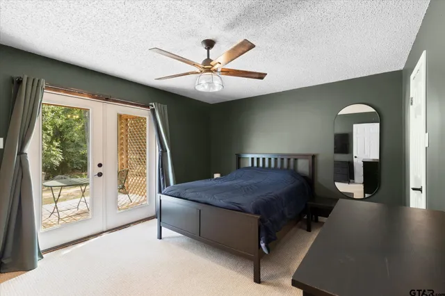 a spacious bedroom with a bed and a large window