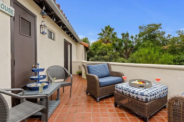 a balcony view with couple of chairs and couch
