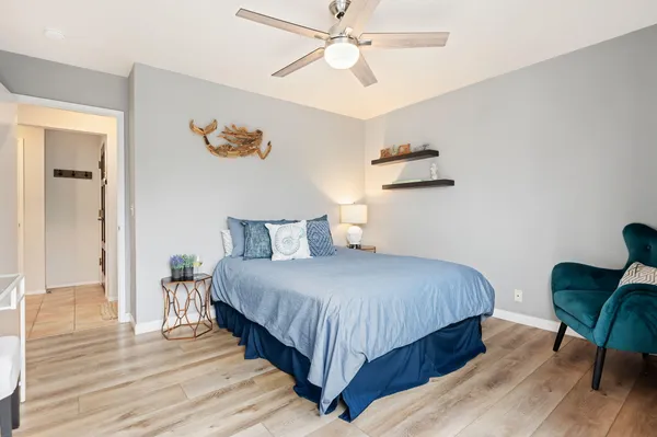 a bedroom with bed and a chandelier