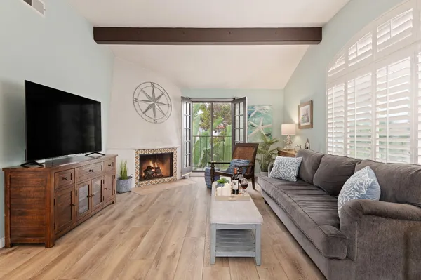a living room with furniture a flat screen tv and a fireplace
