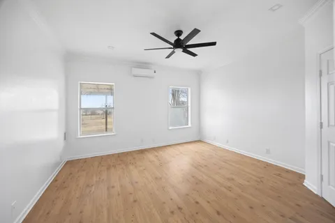 a view of a ceiling fan with wooden floor