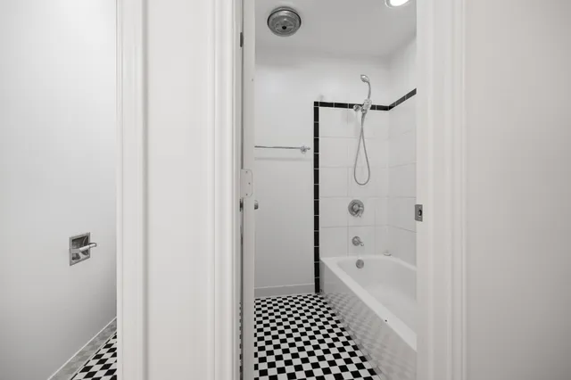 a view of a big room with wooden floor and a ceiling fan