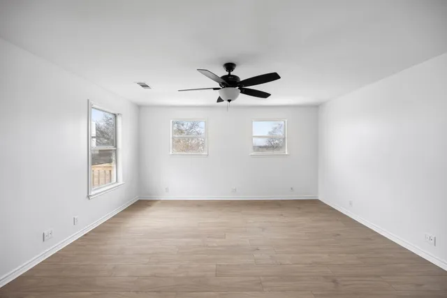 a kitchen with stainless steel appliances granite countertop a refrigerator a sink a stove and oven with wooden floor