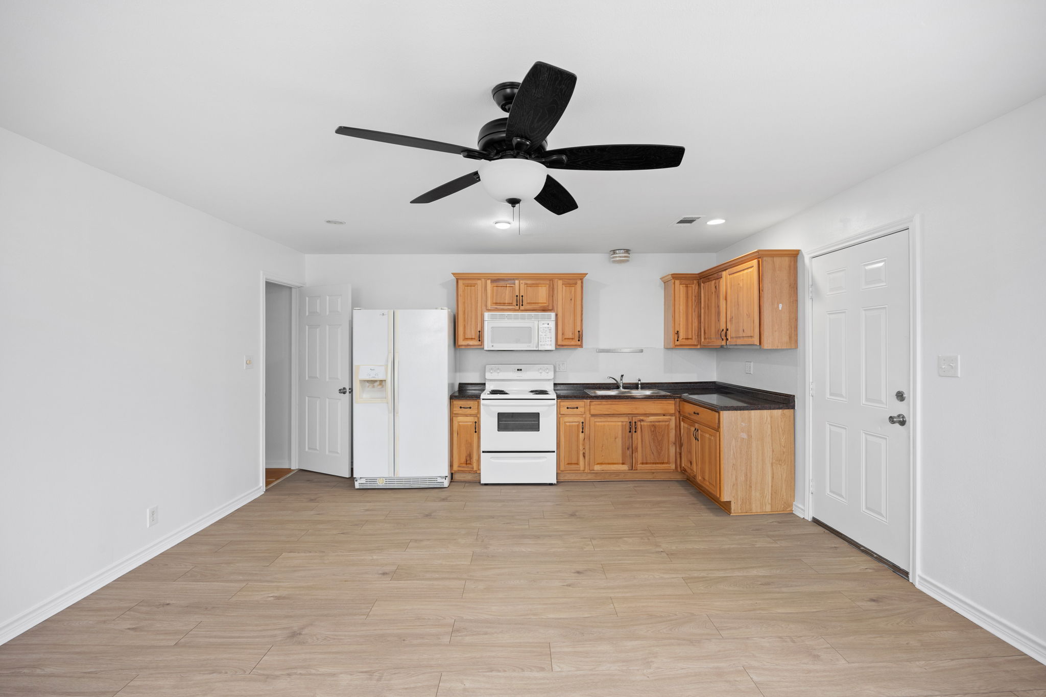 610 Eastview Drive Georgetown, TX 78626 - Photo 22 of 39 a kitchen with stainless steel appliances granite countertop a refrigerator a sink a stove and oven with wooden floor