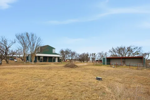 a view of a yard with a tree