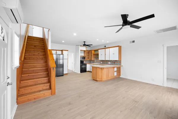 a view of kitchen with cabinets and wooden floor