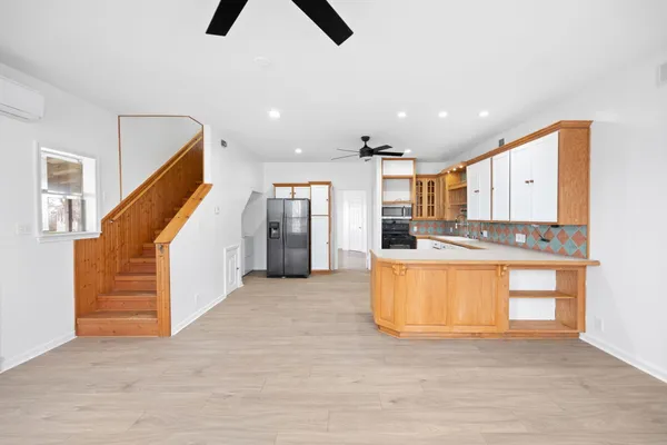 a view of kitchen and hall with wooden floor