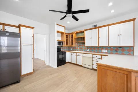 a kitchen with stainless steel appliances granite countertop a refrigerator and a sink
