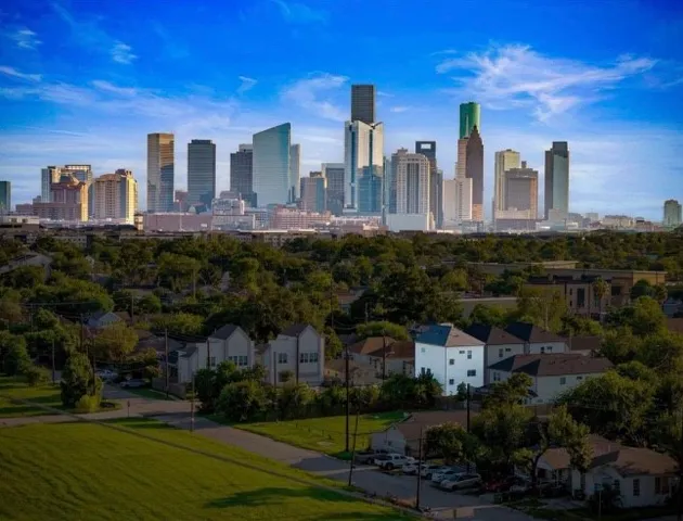 a front view of a residential apartment building with a yard