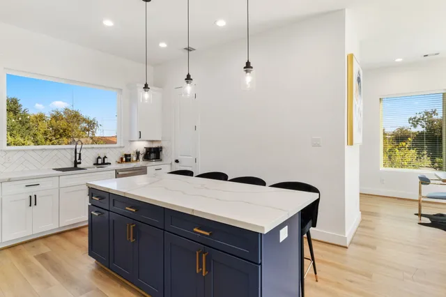 a kitchen with a sink a stove and cabinets