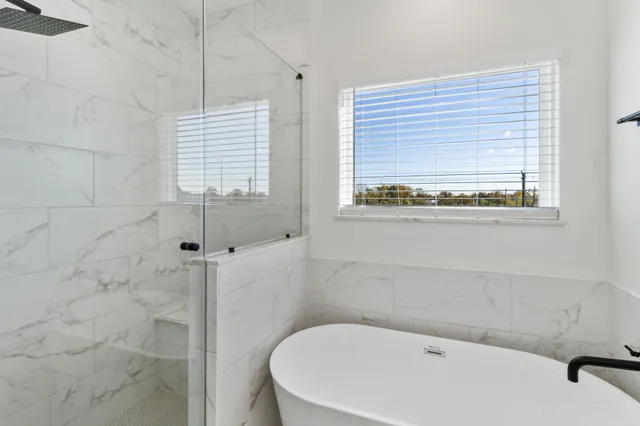 a white bath tub sitting next to a window