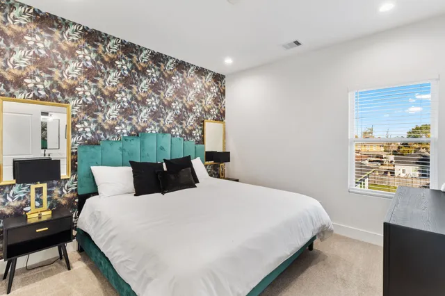 a bedroom with a bed and a flat screen tv