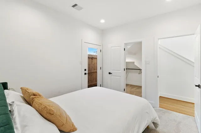 a bedroom with a bed and a mirror