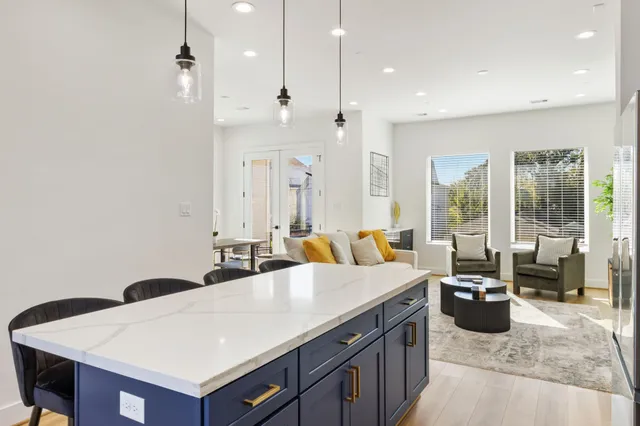 a large kitchen with a large counter top appliances and a ceiling fan
