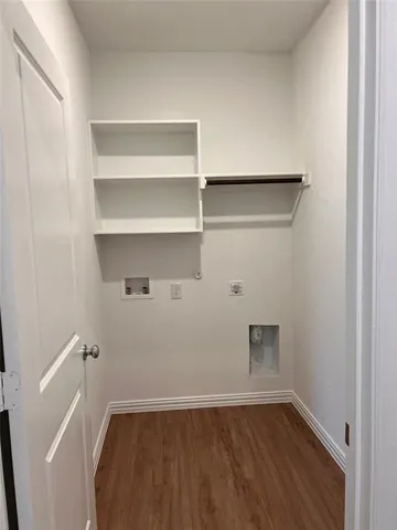 a view of a room with wooden floor