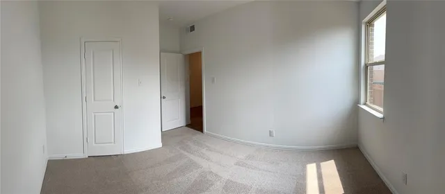 a view of an empty room with a window