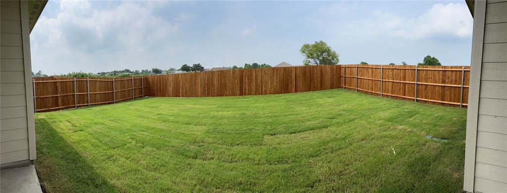 252 Ardsley Lane Princeton, TX 75407 - Photo 18 of 33 a view of a backyard with wooden fence