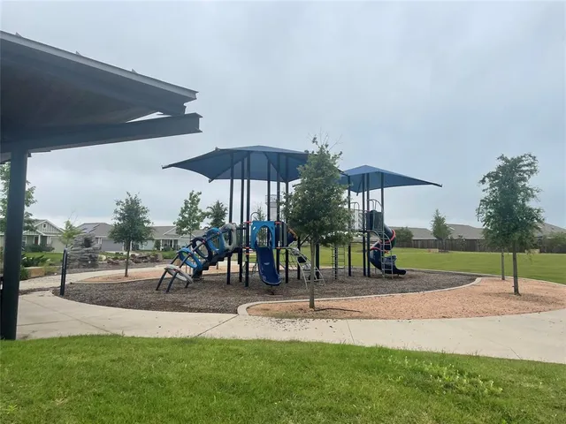a view of a backyard with sitting area