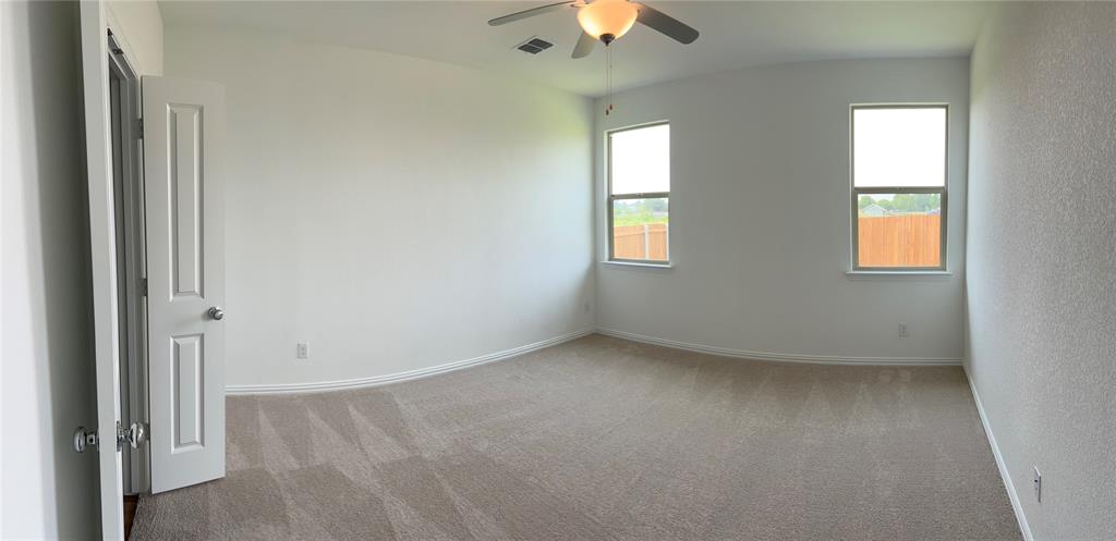 252 Ardsley Lane Princeton, TX 75407 - Photo 7 of 33 an empty room with a window and chandelier fan