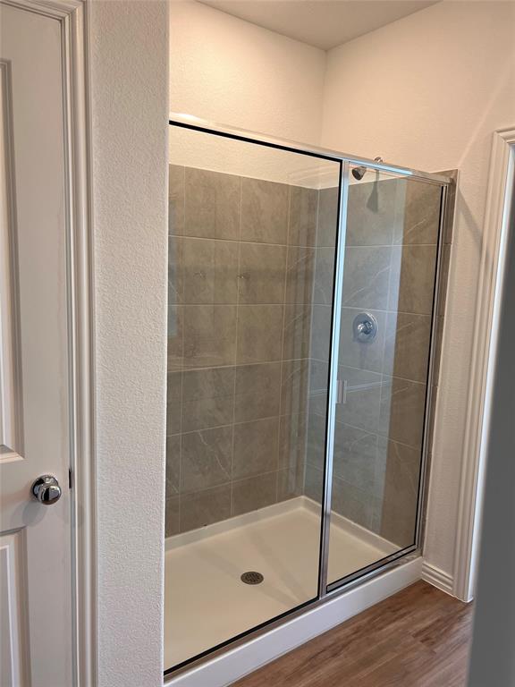 252 Ardsley Lane Princeton, TX 75407 - Photo 8 of 33 a bathroom with a glass shower door