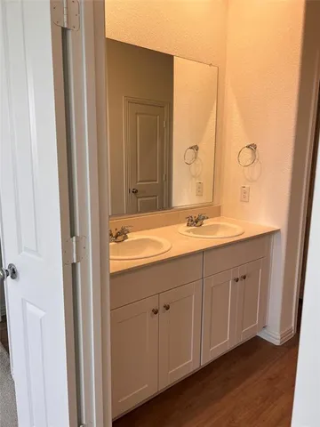 a bathroom with a double vanity sink and mirror