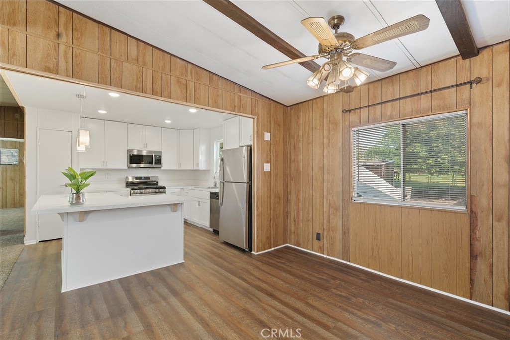 33462 Loquat Street Wildomar, CA 92595 - Photo 27 of 41 a view of kitchen with stainless steel appliances granite countertop a stove top oven a sink with wooden floors
