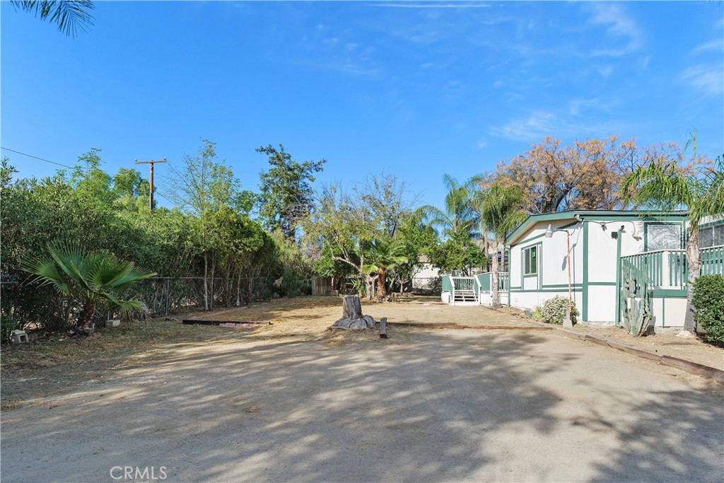 33462 Loquat Street Wildomar, CA 92595 - Photo 3 of 41 a view of a house with a yard and large tree
