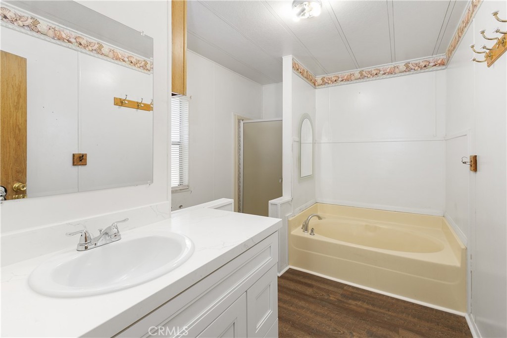 33462 Loquat Street Wildomar, CA 92595 - Photo 37 of 41 a bathroom with a granite countertop sink and a bathtub