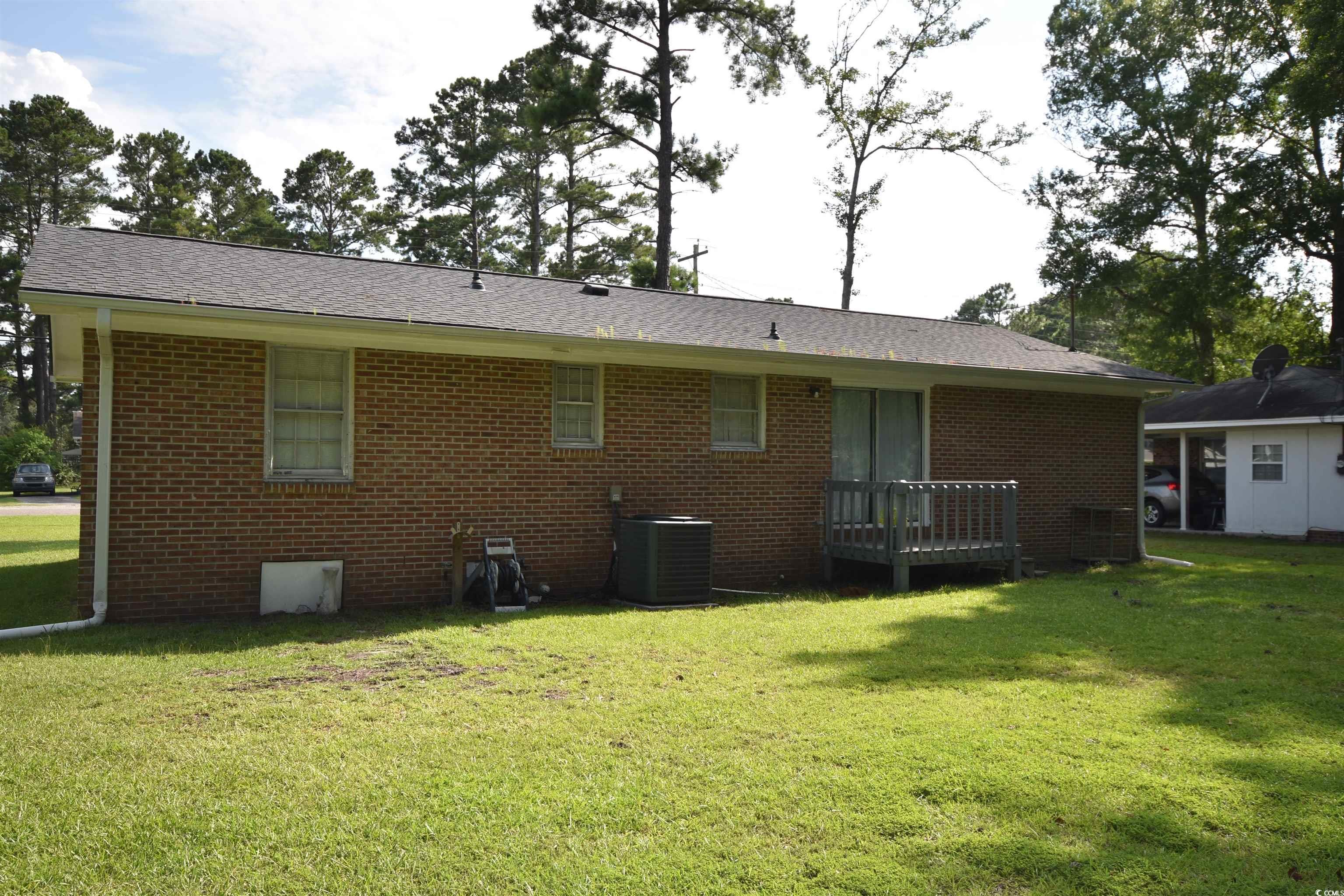 240 County Rd S-22-718 Georgetown, SC 29440 - Photo 3 of 24 Rear view of property featuring brick siding, a yard, and a shingled roof