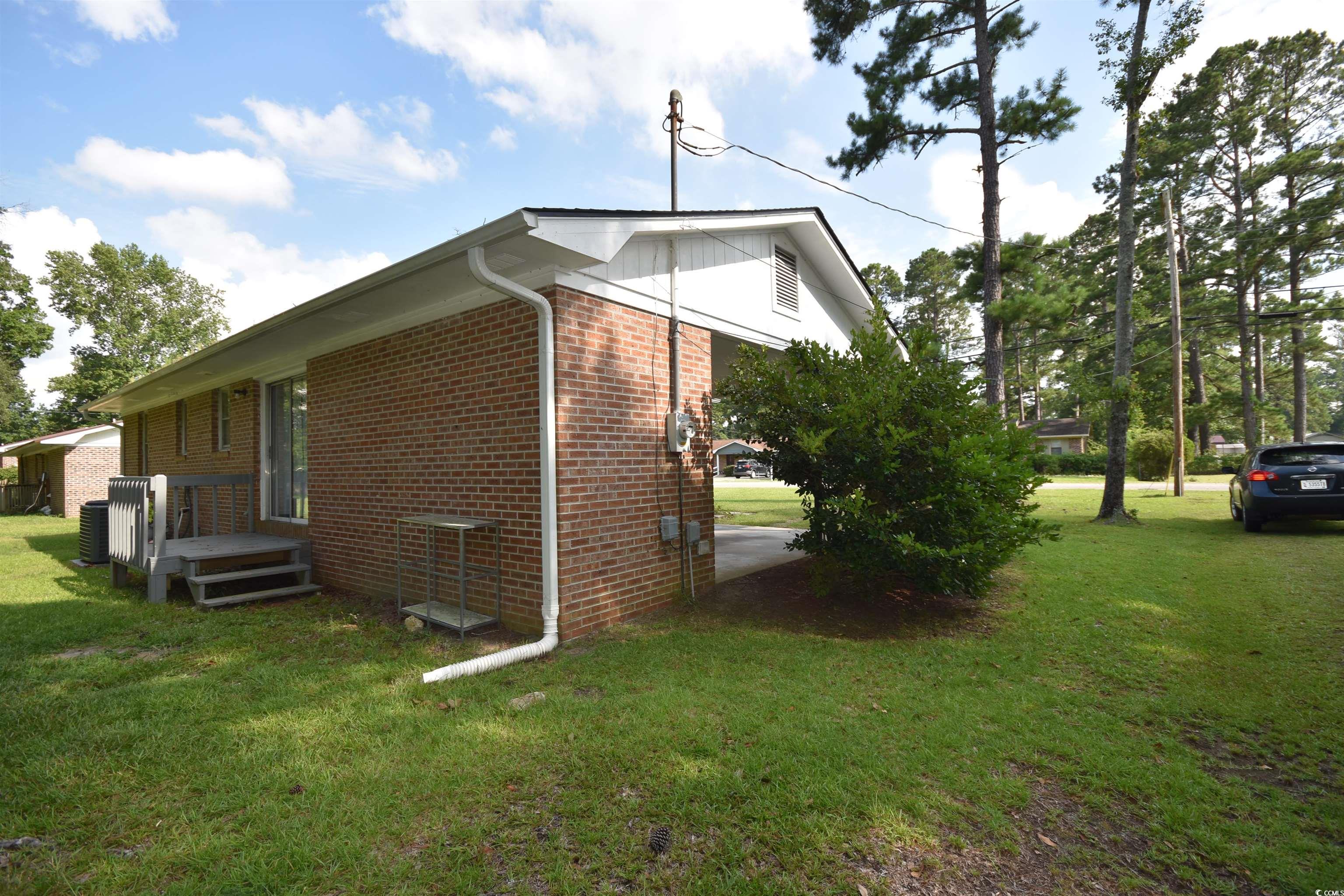 240 County Rd S-22-718 Georgetown, SC 29440 - Photo 6 of 24 View of property exterior with brick siding and a yard